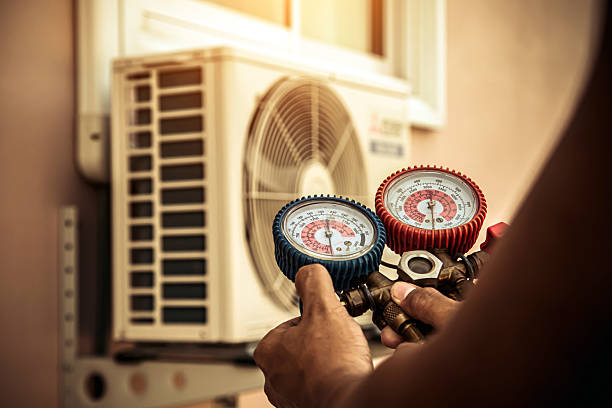 Professional Air Conditioning Service technician working in Lakeville, MA